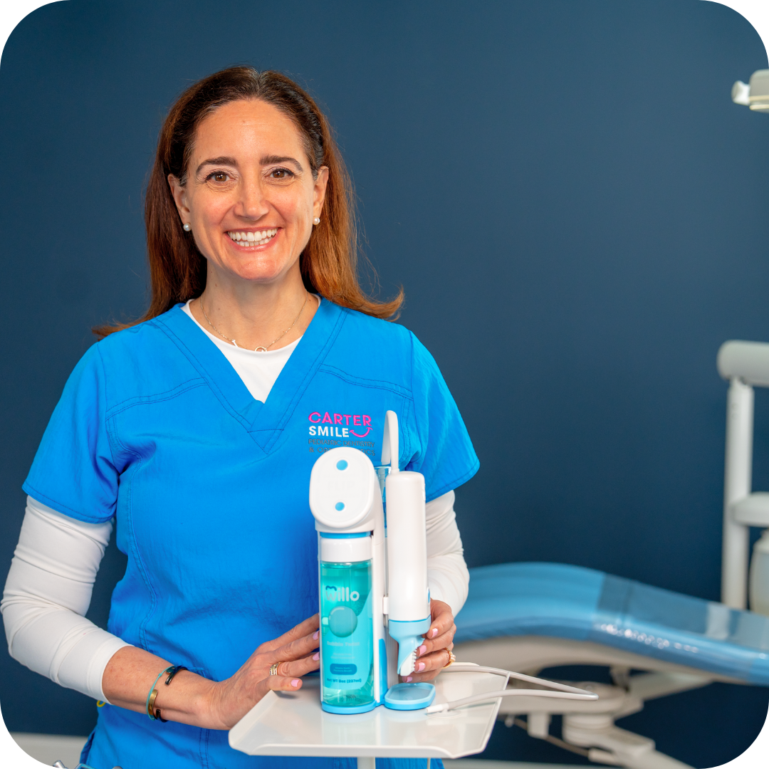 Dental professional holding dental tools against a blue background