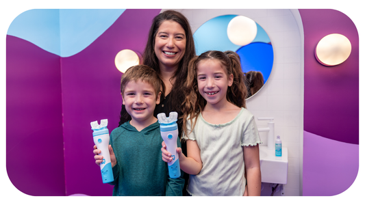two kids under the age of 8 with mom to brush their teeth