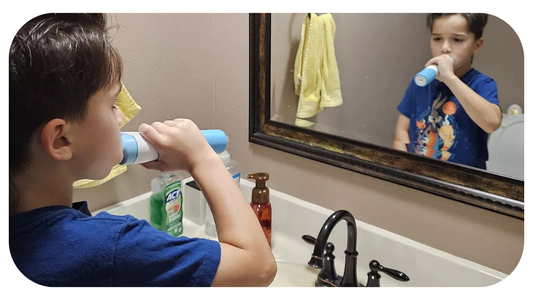 young boy properly brushing his teeth in bathroom