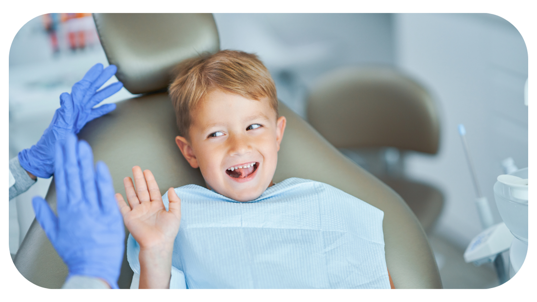 Kid high fiving dentist after brushing his teeth well