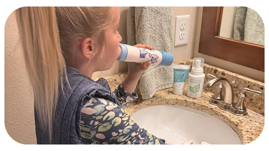 young girl brushing her teeth with willo auto brushing toothbrush in tan bathroom