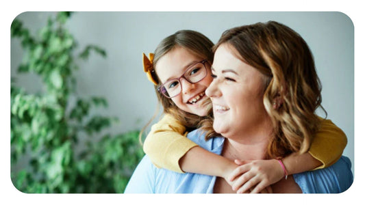 Smiling young girl with glasses giving her mother a piggyback hug during a peaceful morning routine.