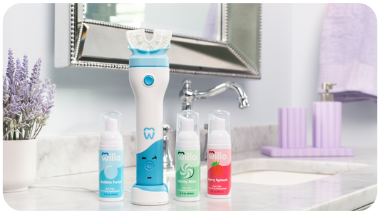 Willo kids automatic brushing toothbrush and 3 flavors of kids foaming toothpaste in a bright bathroom