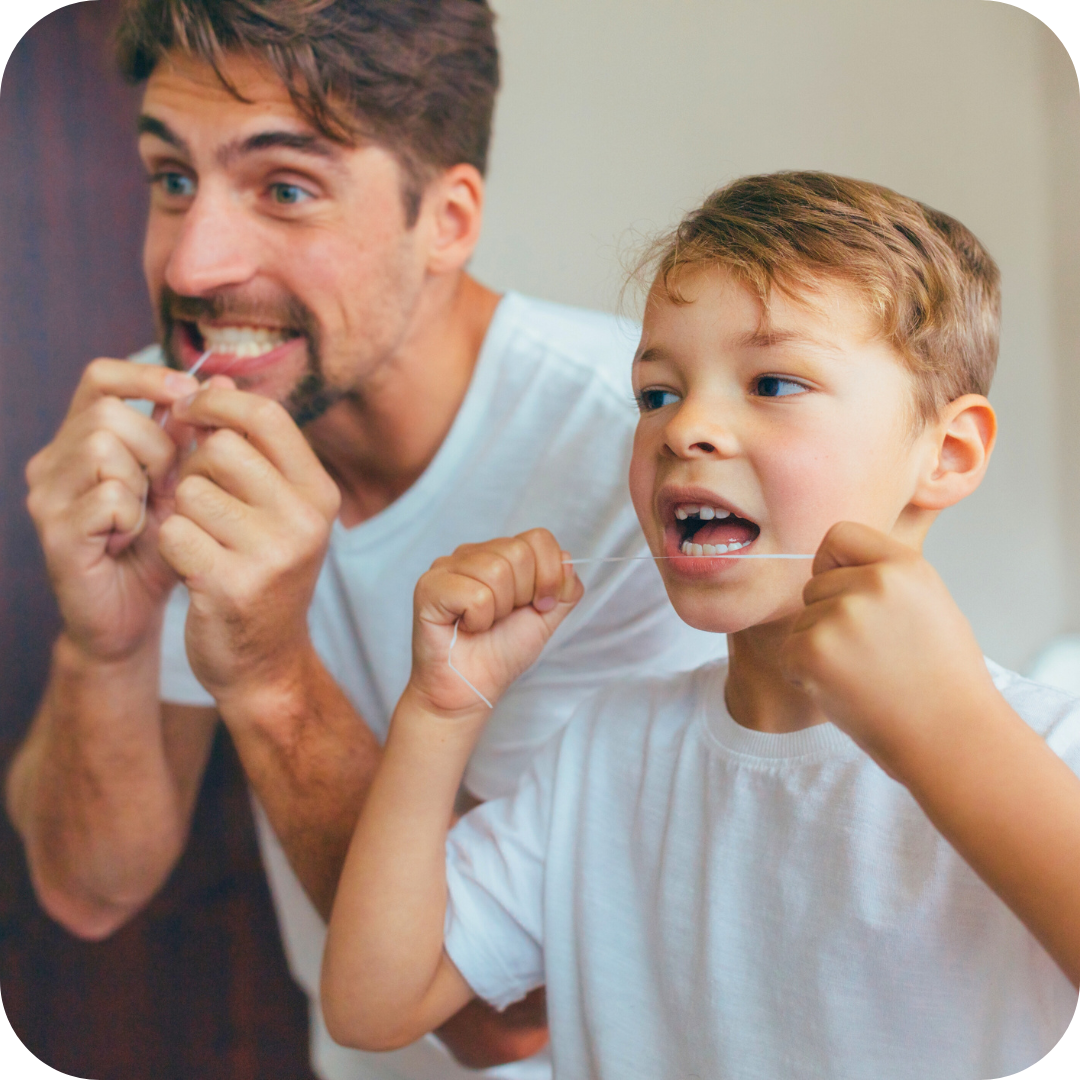 dad and son flossing teeth
