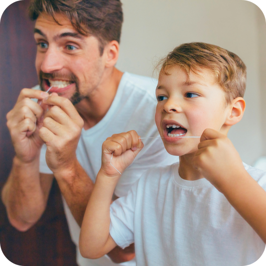 dad and son flossing teeth