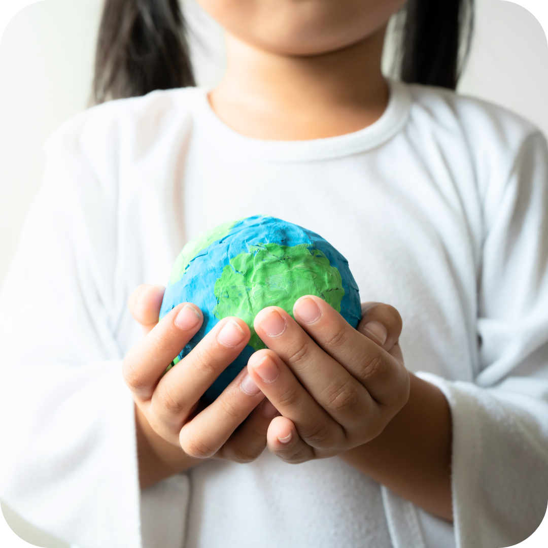 Girl holding recycled earth to represent Willo sustainability practices