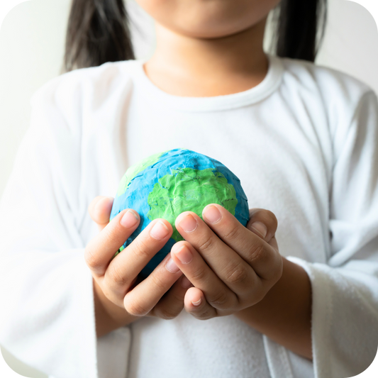 Girl holding recycled earth to represent Willo sustainability practices
