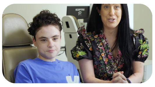 Mom of autistic son and her son sit next to each other and discuss Willo toothbrush