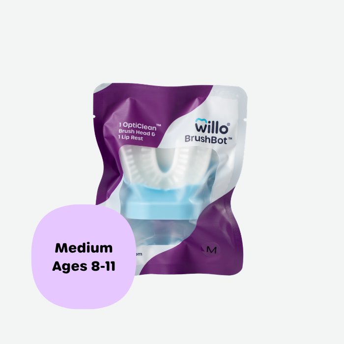 Willo BrushBot medium replacement pack containing one OptiClean brush head and one lip rest for kids ages 8 to 11. Sealed purple and white product packaging featuring the Willo brand logo.