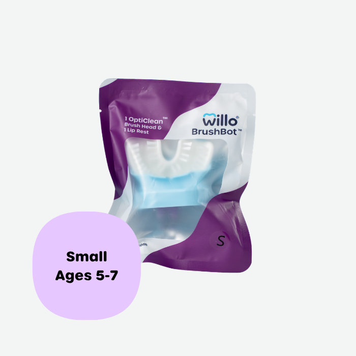 Willo BrushBot small replacement pack containing one OptiClean brush head and one lip rest for kids ages 5 to 7. Sealed purple and white product packaging displaying the Willo logo.