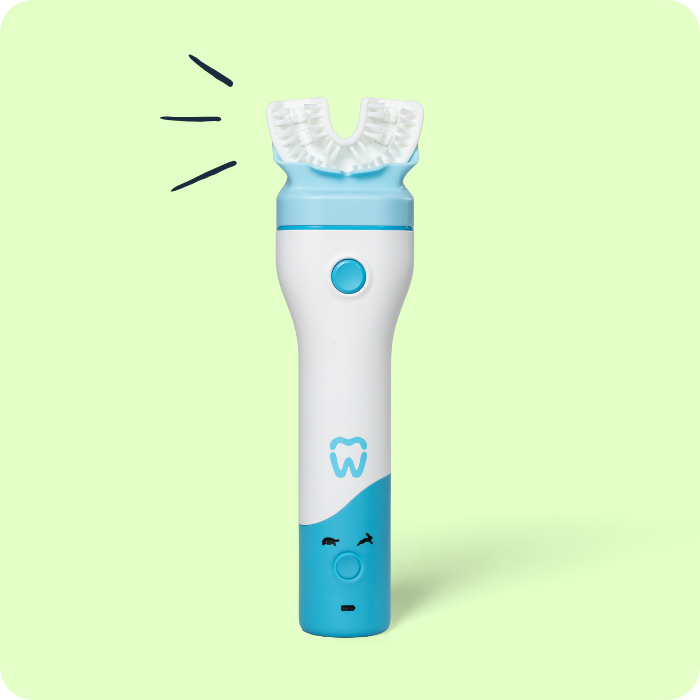 A studio product shot of the Willo automated toothbrush handheld wand against a soft green background. The white and blue ergonomic handle features a central blue power button, a blue tooth logo emblem, and a multi-bristle silicone mouthpiece attached to the top. Three small, hand-drawn black accent lines radiate outward near the left side of the mouthpiece.