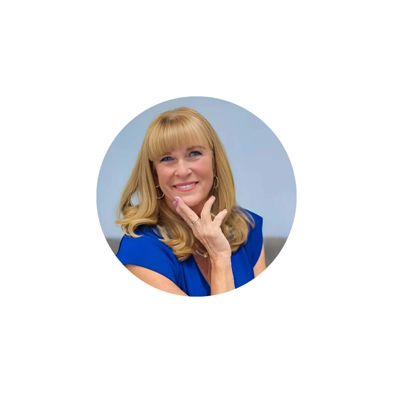 Circular profile picture of a woman with blonde hair and a blue top on a light gray background