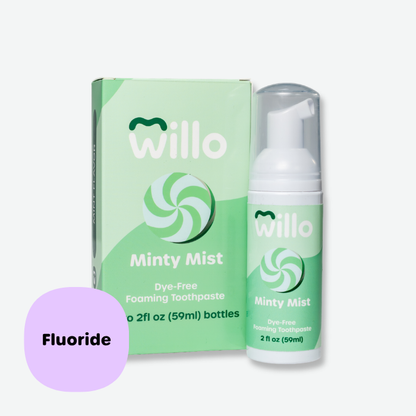 Willo Minty Mist dye-free foaming toothpaste with fluoride pump bottle and retail box. Features a green mint swirl graphic design and a purple callout badge highlighting the 2 fl oz (59ml) fluoride formula.
