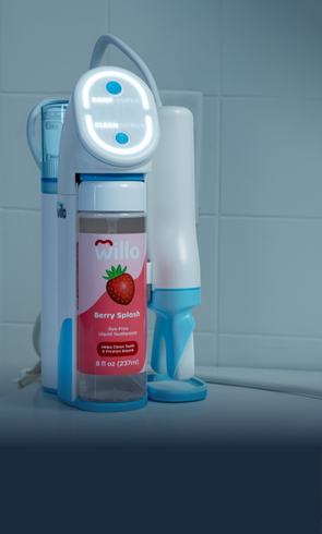 Wello kids toothbrush with a berry splash bottle on a tiled bathroom counter