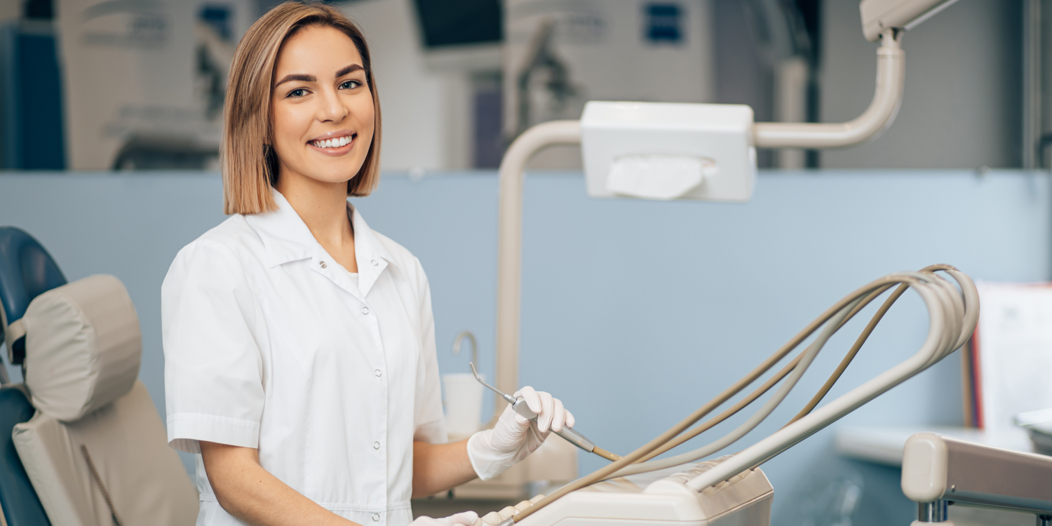 Dental professional in a clinic setting with dental tools.