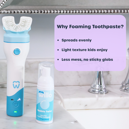 Electric toothbrush and foaming toothpaste on a bathroom counter with text about foaming toothpaste.