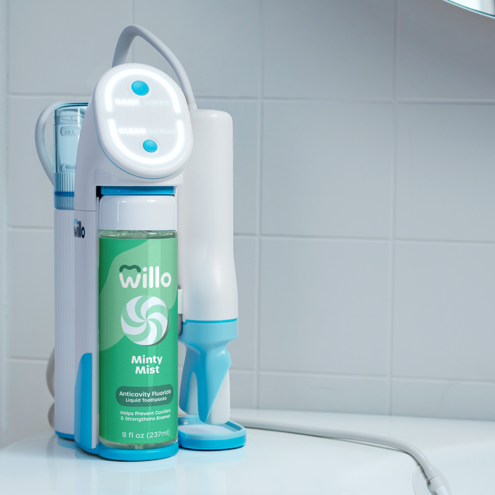 Willo Minty Mist auto brushing kids toothbrush on a bathroom counter.